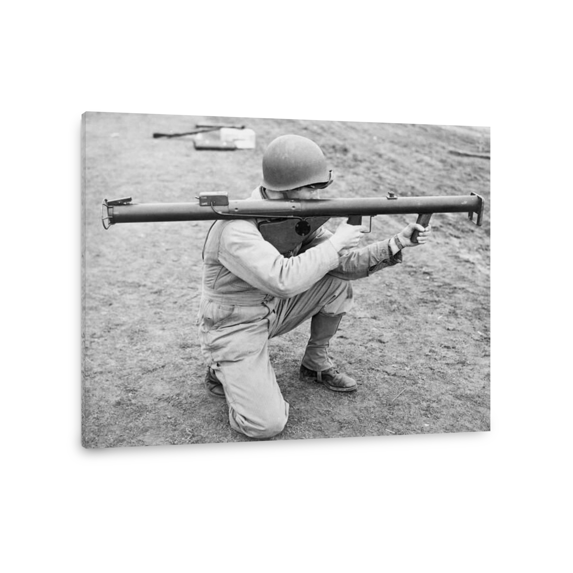 A soldier kneeling and aiming a bazooka, 1943, England.
