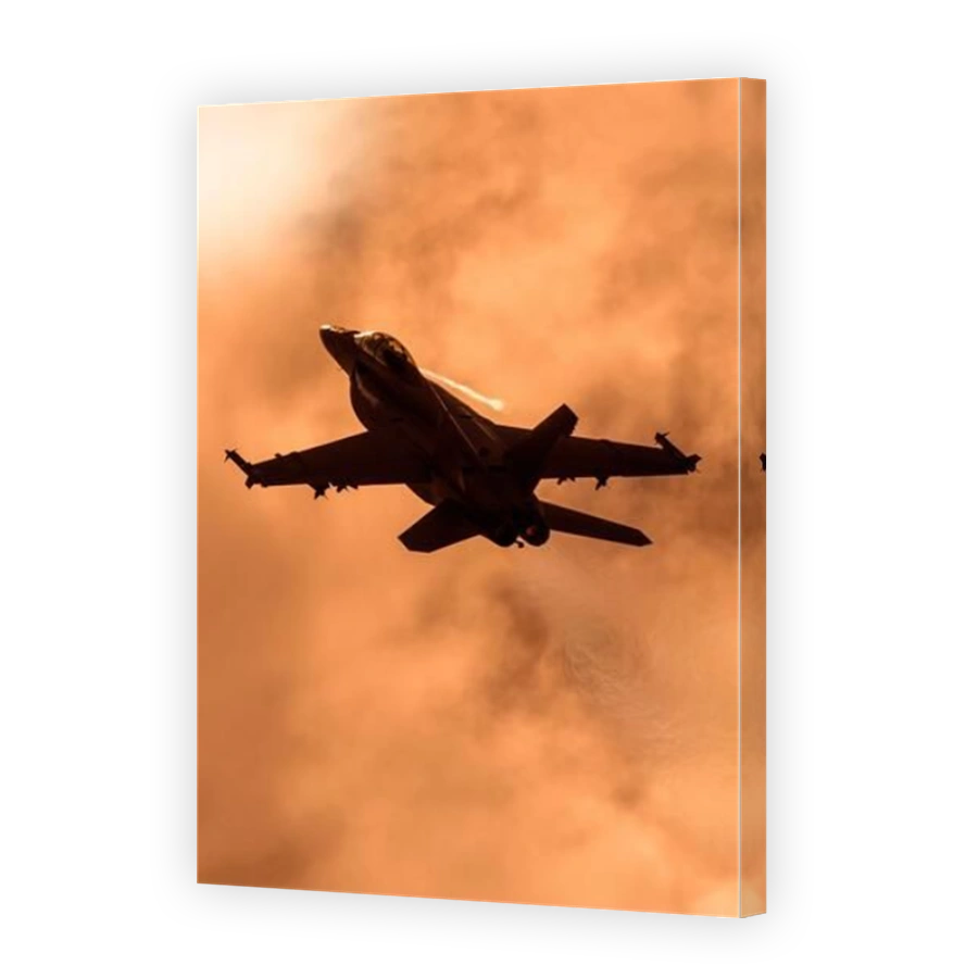 US Navy F/A18 Super Hornet climbing into a sunset sky, showing the disturbed air or eflux in its wake.