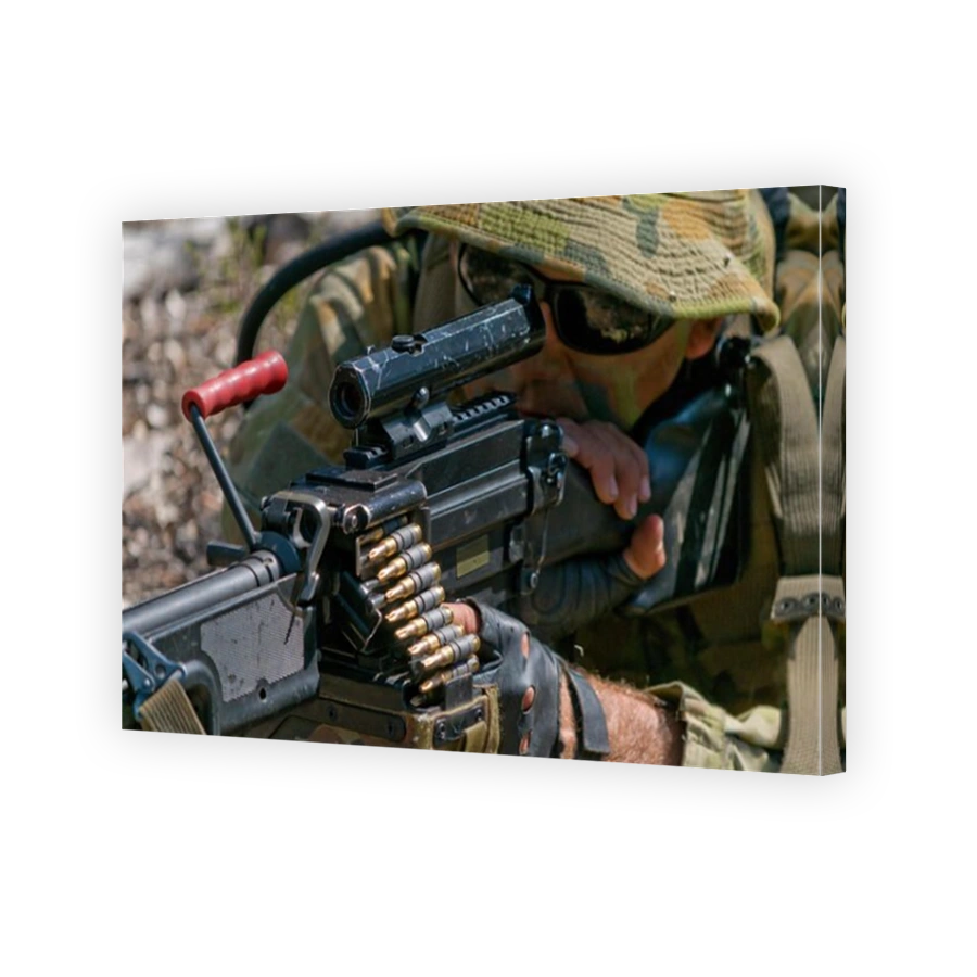 Australian Army reserve soldier aiming a Light Support Weapon (LSW) MAG 58 machine gun. He is wearing a typical 'Aussie' slouch hat.