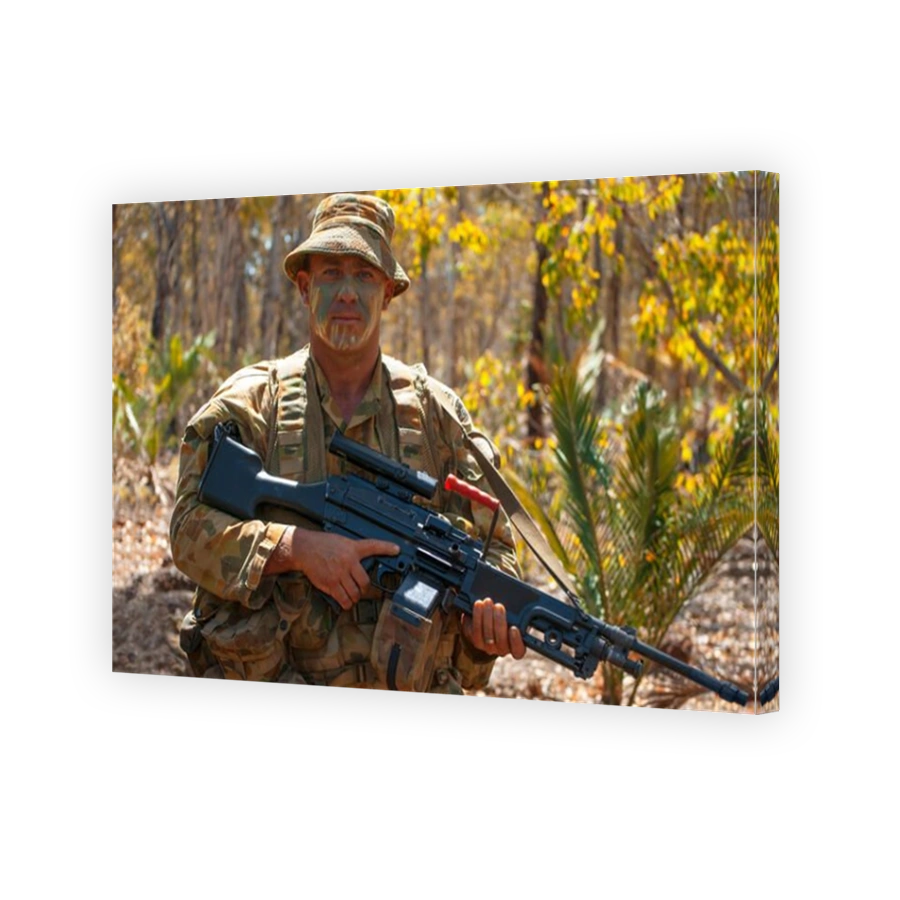 Australian soldier in camouflage, with machine gun in the Australian bush