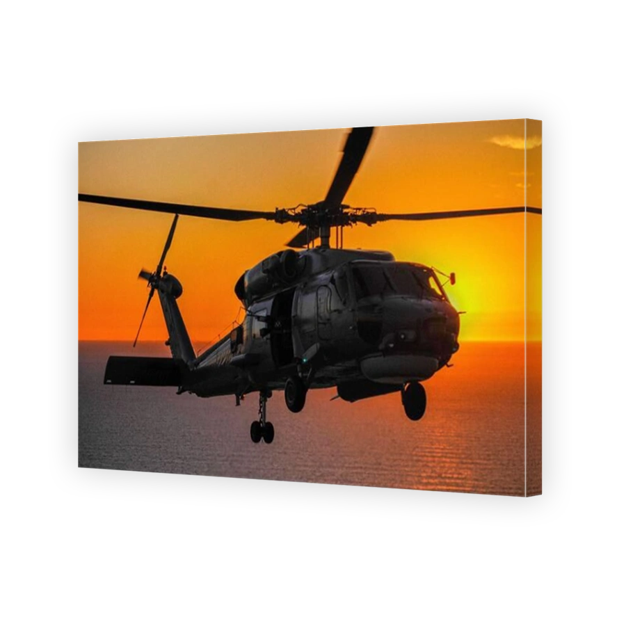 An air-to-air- portrait of an Australian Navy Sikorsky S70B Seahawk helicopter at sunset