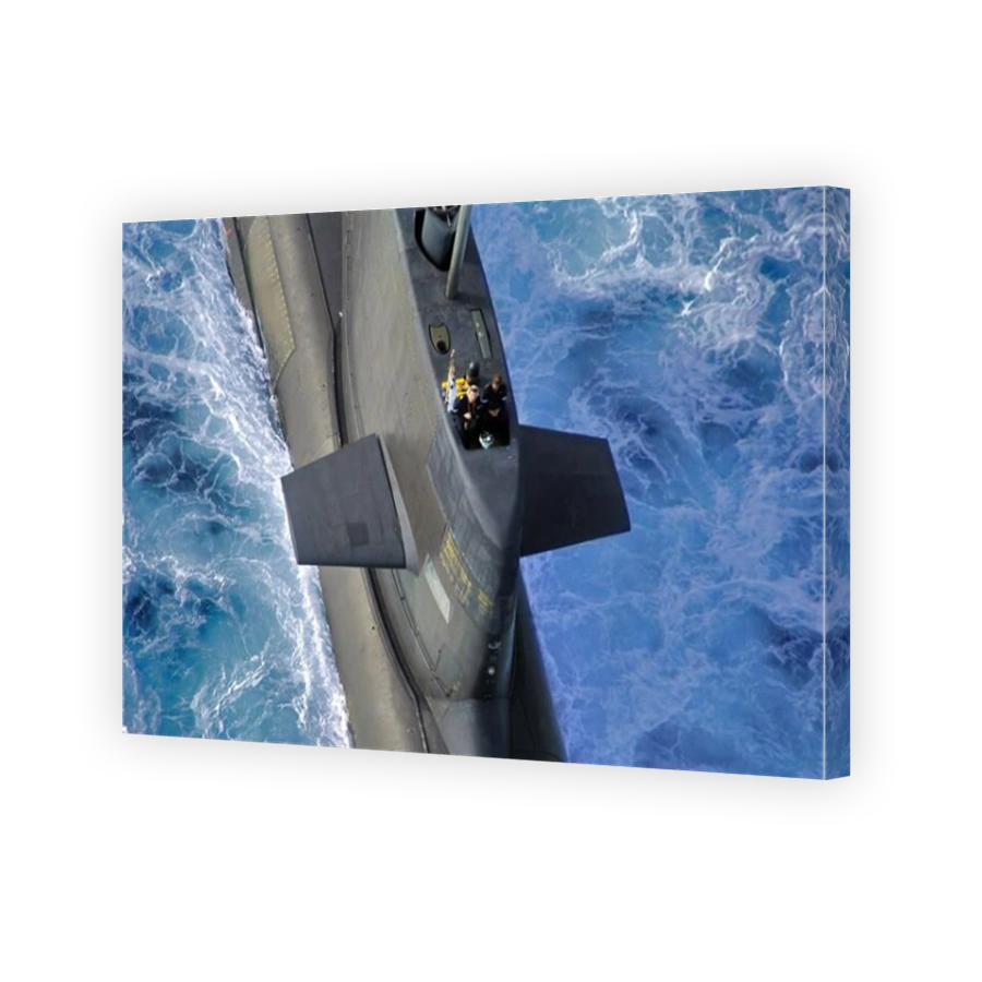 An close up aerial view of an Australian Navy Collins Class diesel electric submarine at sea. Looking down on to the coning tower, or fin.