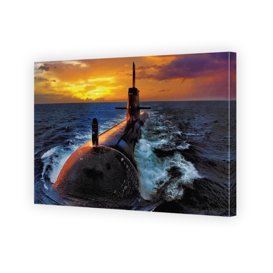 A close up view of a dramatic sunset illuminating an Australian Navy Collins Class diesel electric submarine at sea.