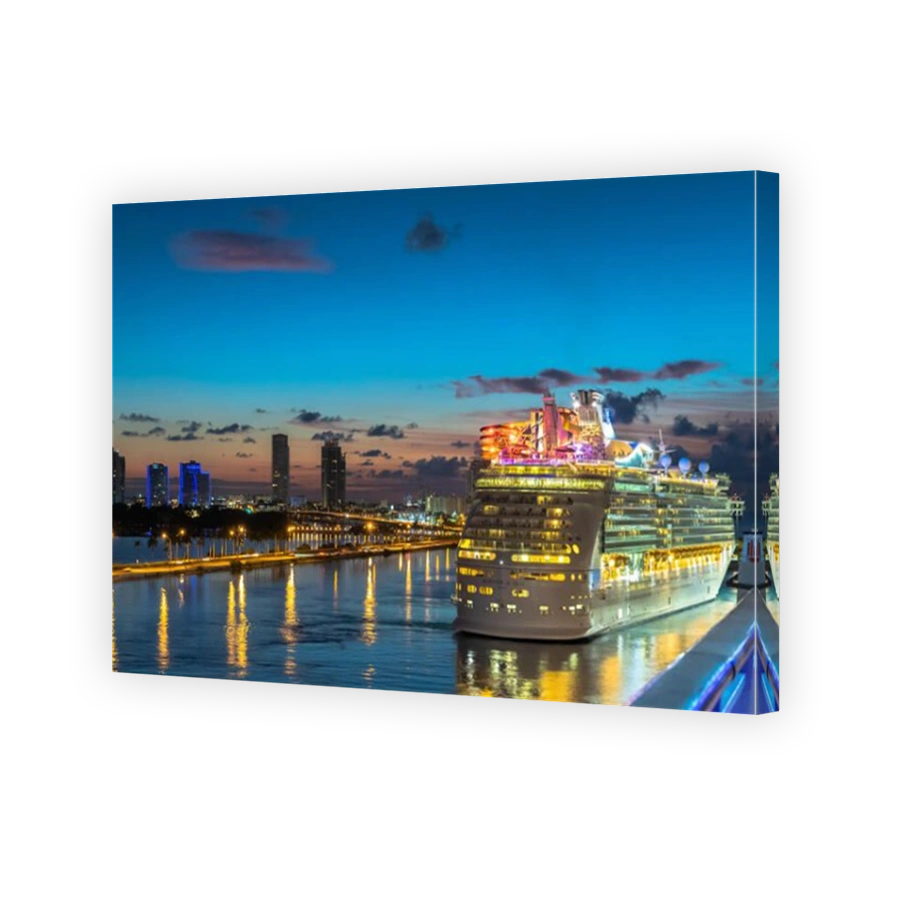 Miami, Florida - November 19 2018: Royal Caribbean Cruise Line Mariner Of The Seas Cruise Ship sailing in the Port of Miami at sunrise with skyline of